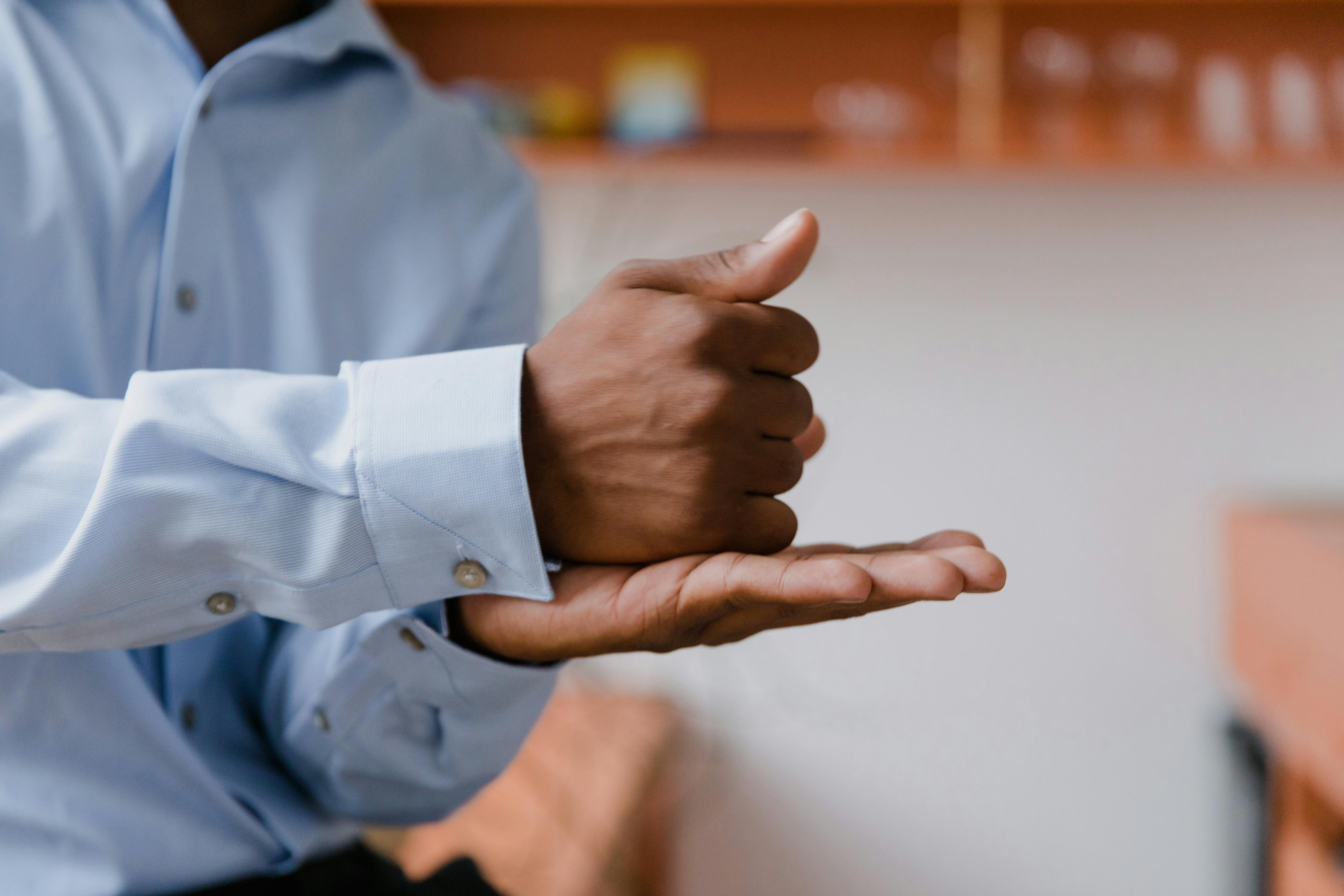 Credentialed sign language interpreter, hands mid-sign